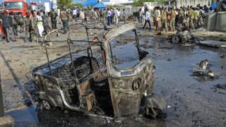 The wreckage of a vehicle is seen at the site of the car bomb explosion which killed at least four people outside of the Somali parliament in Modadishu on March 25, 2018
