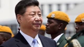 Chinese President Xi Jinping inspects the guard of honour following his arrival in Harare, Zimbabwe