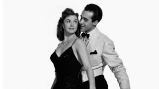 American actress and swimmer Esther Williams wearing a long evening dress and dancing with Mexican actress Ricardo Montalban in the film Neptune's Daughter, 1949