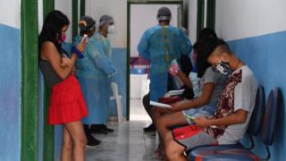 Brazilian indigenous people wait to see doctors at a health post in Amazonas state in northern Brazil.