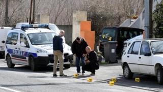 Police officers secure evidence during a police operation underway near Trebes near Carcassonne, southern France, 23 March 2018