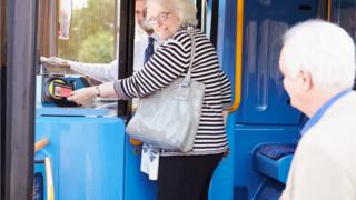 Pensioner getting on bus