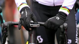 A Garmin device is seen mounted to the handlebar of an expesnive racing bike