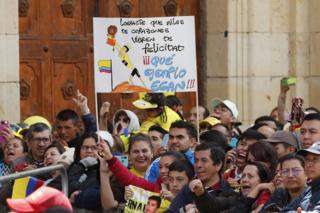 Fans hold a sign that reads "You made millions of hearts shake with happiness. What an example, Egan!" during a tribute to Colombian cyclist Egan Bernal, winner of the Tour de France 2019, at his hometown, Zipaquira, in Cundinamarca, Colombia