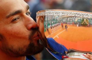 Italy's Fabio Fognini celebrates by kissing the trophy after winning the ATP 1000 - Monte Carlo Masters