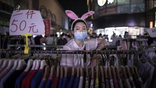 Market seller in China dressed as a rabbit