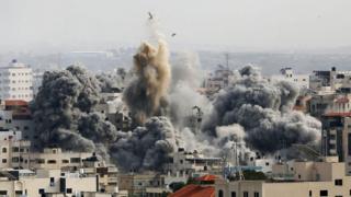 Smoke rises over buildings as Israeli airstrikes continue in Gaza City, Gaza on 9 October 2023