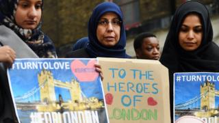 Muslim ladies hold placards at London vigil