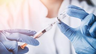 image of a female doctor with syringe