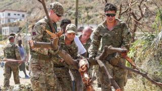 British troops dey carry tree as dem dem help people for Tortola, one of the British Virgin Islands