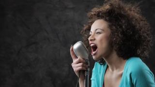 Woman shouting into microphone