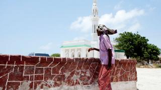 Somali man walks past a mosque