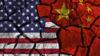 Technology American and Chinese flags painted on cracked wall background