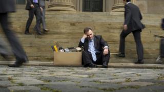 Banker on steps of bank