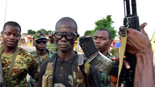 Mutinous soldier pose with their weapons in the streets of Ivory Coast's central second city Bouake