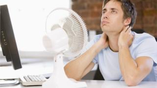 Man next to fan