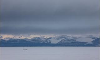 Antarctic landscape with mountains and tents