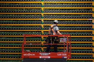 A technician inspects computers mining bitcoin in Quebec A technician inspects computers mining bitcoin in Quebec