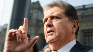 Former Peruvian president Alan Garcia talks to the media as he arrives at the National Prosecution office in Lima, Peru March 27, 2018