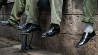 A picture of police officers in worn-out shoes