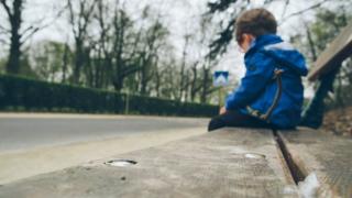 A boy sitting on a bench