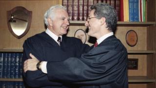 In this Friday, Oct. 13, 1989, file photo, retired Judge Joseph A. Wapner of TV"s "The People"s Court" congratulates his son, Judge Frederick N. Wapner, right, as he was enrobed as a Municipal Court judge in Los Angeles