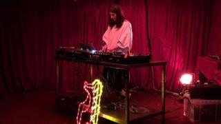 Kitty Clark performing at SET's Bar in Dalston. The bar provides a source of income and helps to promote musicians and artists