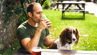 Man and dog in a pub garden