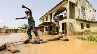 A man makes his way through flood waters in Kogi State, Nigeria September 17, 2018.