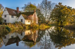 A cottage reflected in a river