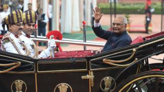 India's new President Ram Nath Kovind waves from a horse-drawn carriage during a ceremony at the Presidential Palace in New Delhi