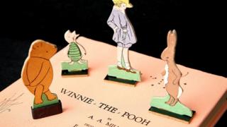 Winnie-the-Pooh, Piglet, Christopher Robin and Kanga as cutout characters on an old edition of the Winnie-the-Pooh book