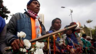Indigenous Colombians rally for national peace agreement during a march with white flowers in Bogota, Colombia, October 12, 2016