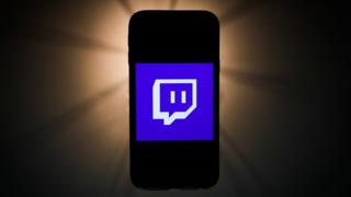 environment Twitch logo on a phone