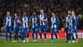 Brighton players watch the FA Cup semi-final penalty shootout