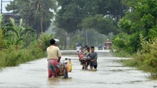 n this photograph taken on August 1, 2015, Indian villagers wade through floodwaters in Bherampur Block, Murshidabad District, some 220kms north of Kolkata