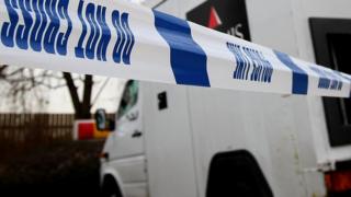 This file photo shows police incident tape around a Loomis security van in London
