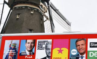 Election poster billboard seen near a windmill in Amsterdam, Netherlands, March 14, 2017