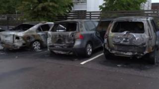 Burned cars are seen in a row in Gothenburg, Sweden