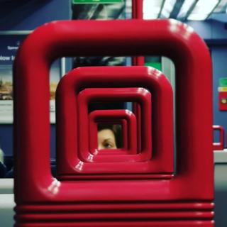 Red train chair handles in a row