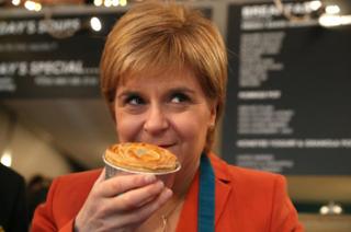 SNP Leader Nicola Sturgeon savours the aroma of a haggis pie featuring the party's logo that she helped to make on a campaign visit to Table 13 Express in Kirkintilloch, East Dunbartonshire.