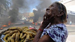 Mujer vendiendo bananos en Tegucigalpa durante una protesta