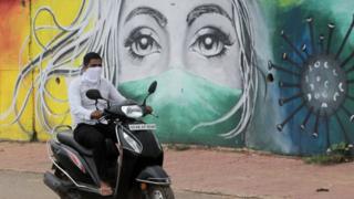 An protective mask wall painting is seen on wayside to create awareness for people in between the coronavirus pandemic lockdown period in Bhubaneswar, India, on August 10, 2020.