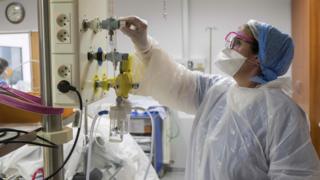Member of medical staff adjusts oxygen supply in French hospital