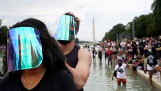 Protesters stand in the Lincoln Memorial Reflecting Pool during the 2020 March on Washington