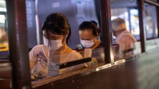 Woman wears mask on Hong Kong bus