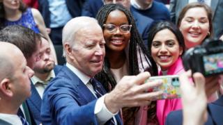 Joe Biden takes a selfie with students on the 25th anniversary of the Belfast/Good Friday Agreement, at Ulster University, Belfast, Northern Ireland April 12, 2023. REUTERS/Kevin Lamarque