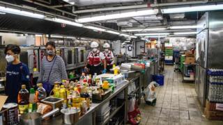 A team walk though a canteen kitchen at PolyU