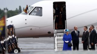 The Queen disembarks from a plane in Germany