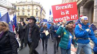 People marching through Leeds with anit-anti placards